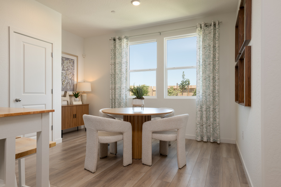 A dining room with a table and chairs.