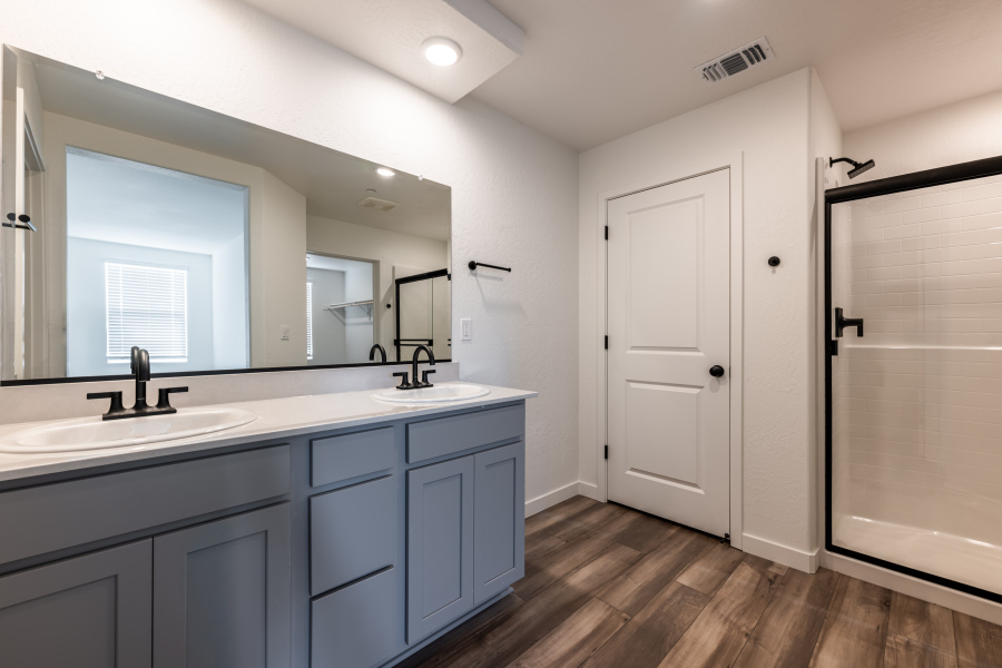 A bathroom with white cabinets.