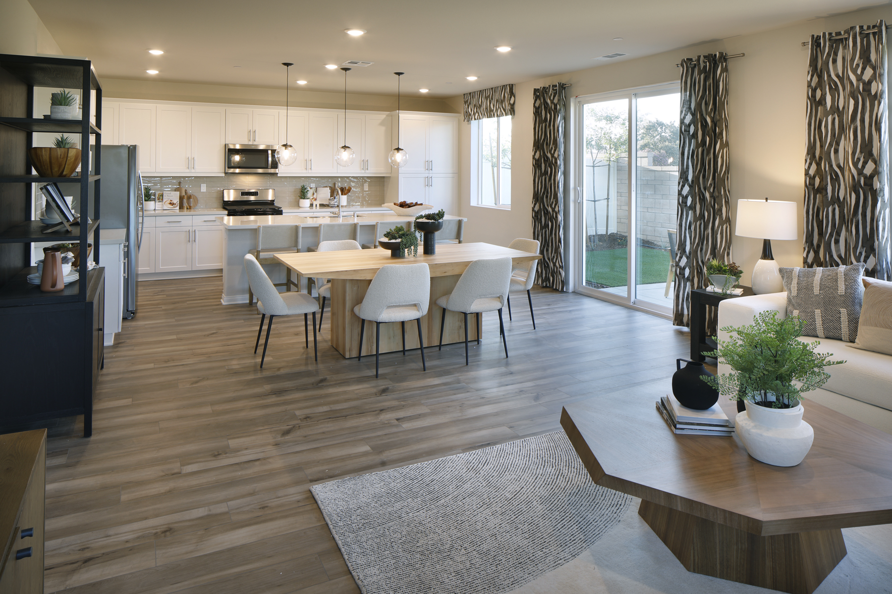 A large kitchen with a dining table.