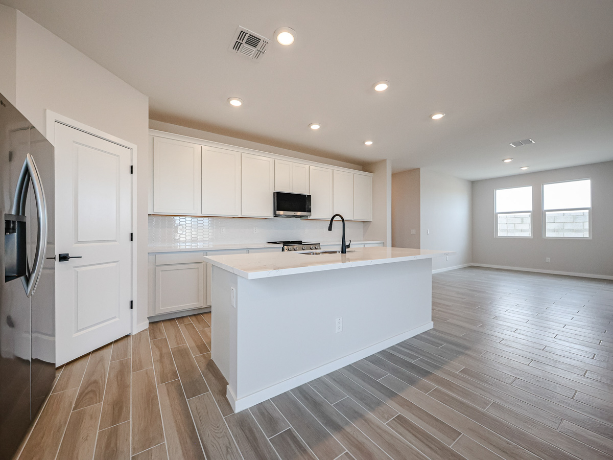 A kitchen with white cabinets.