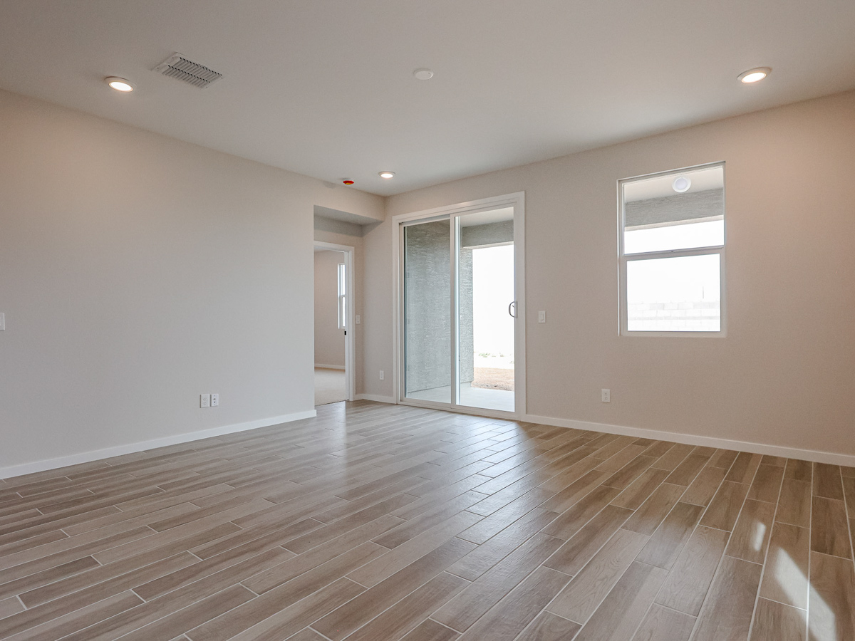 A room with a wood floor and a wood floor with a window.