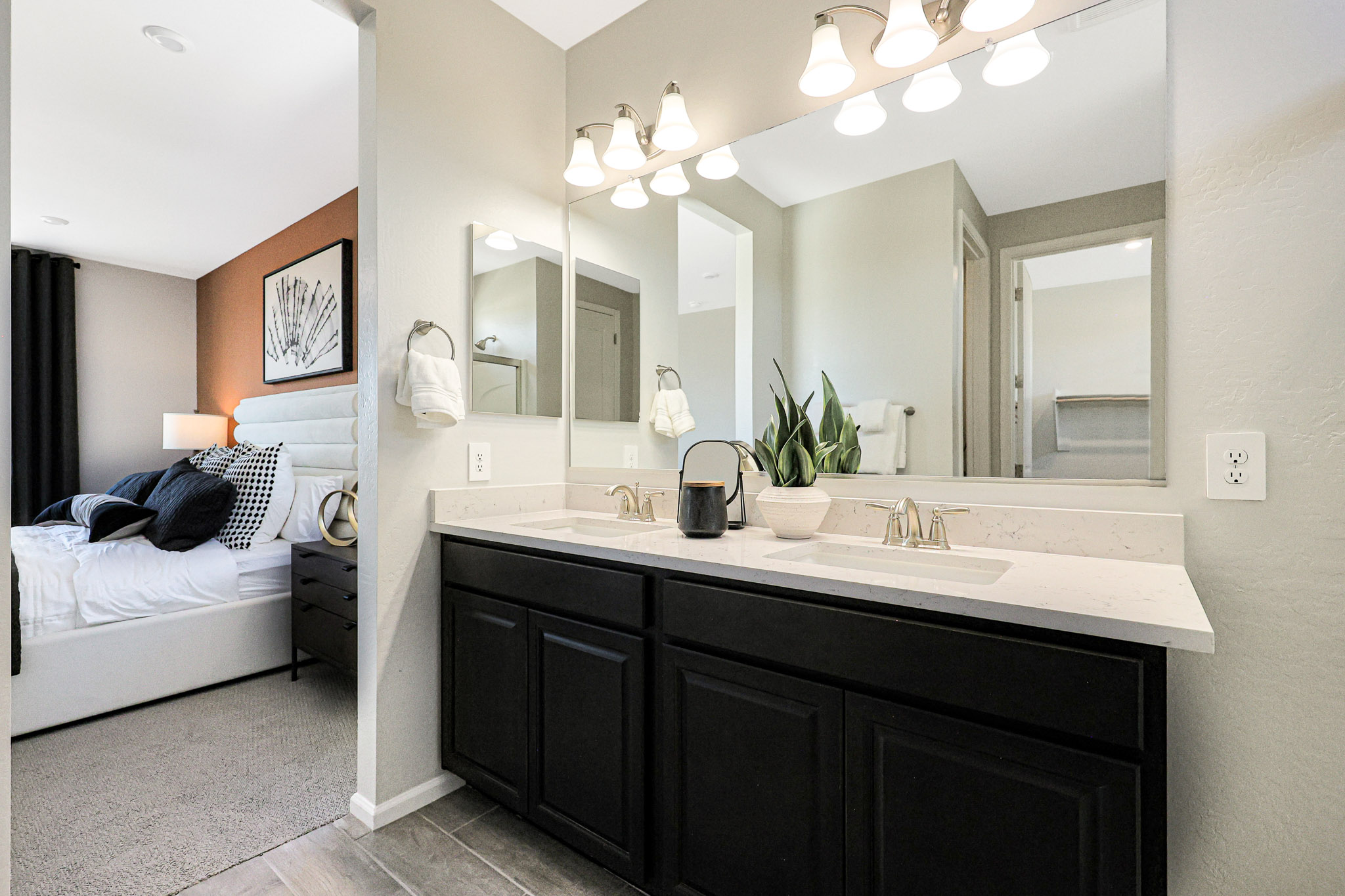 A bathroom with a sink and a bed.