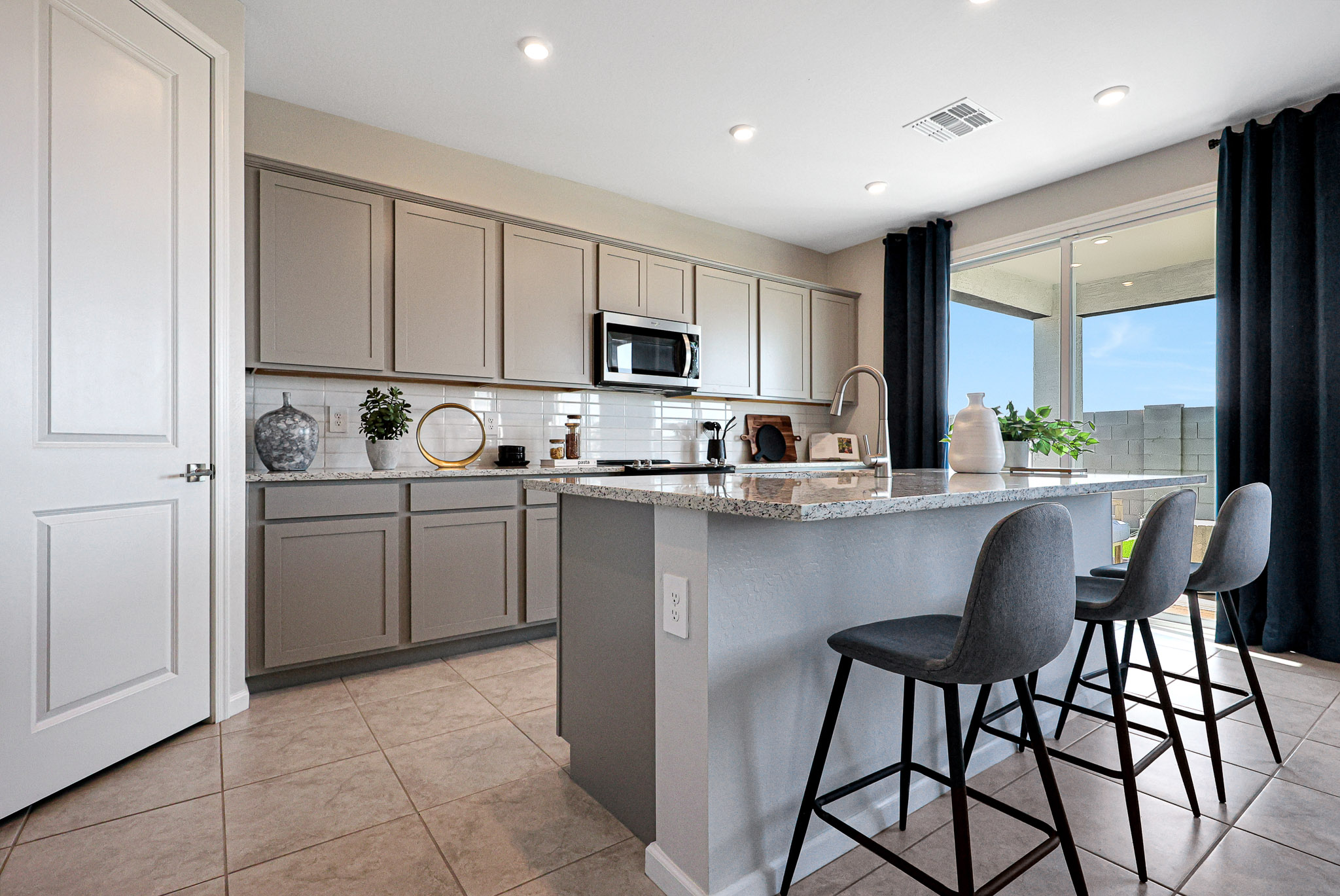 A kitchen with a marble island.