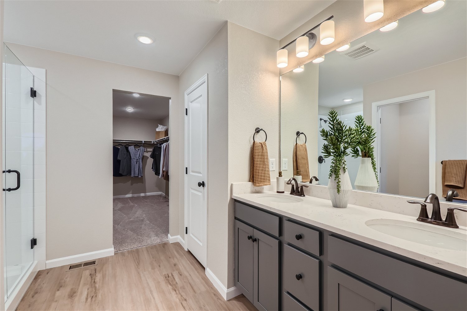 A bathroom with a large mirror.
