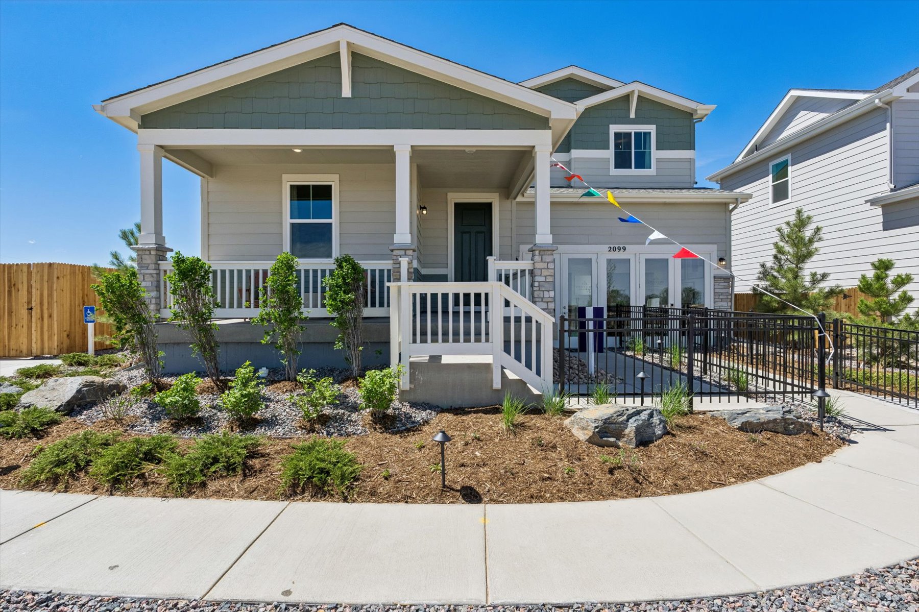 A house with a fence and bushes.