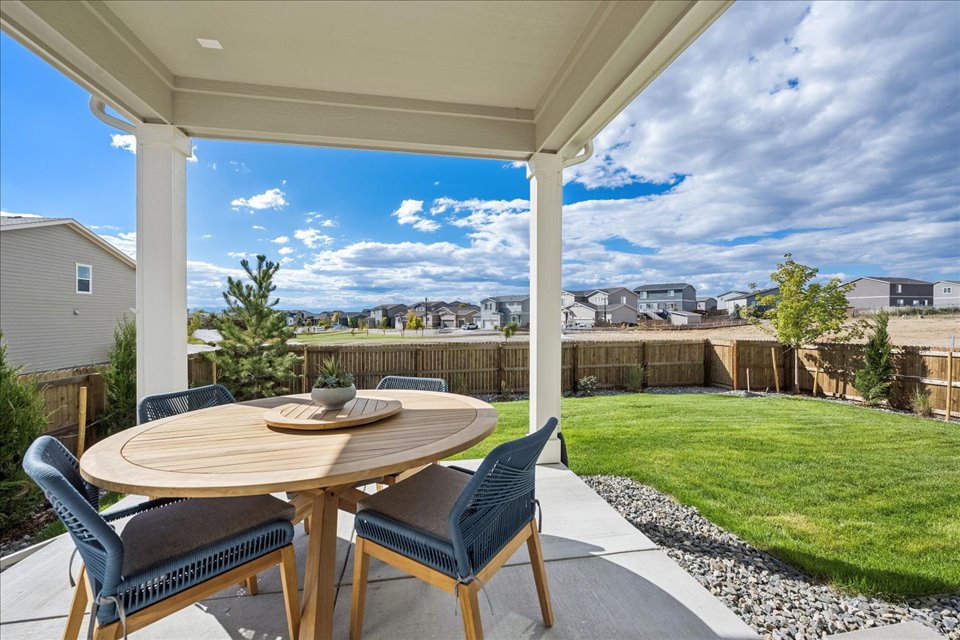 A table and chairs on a patio.