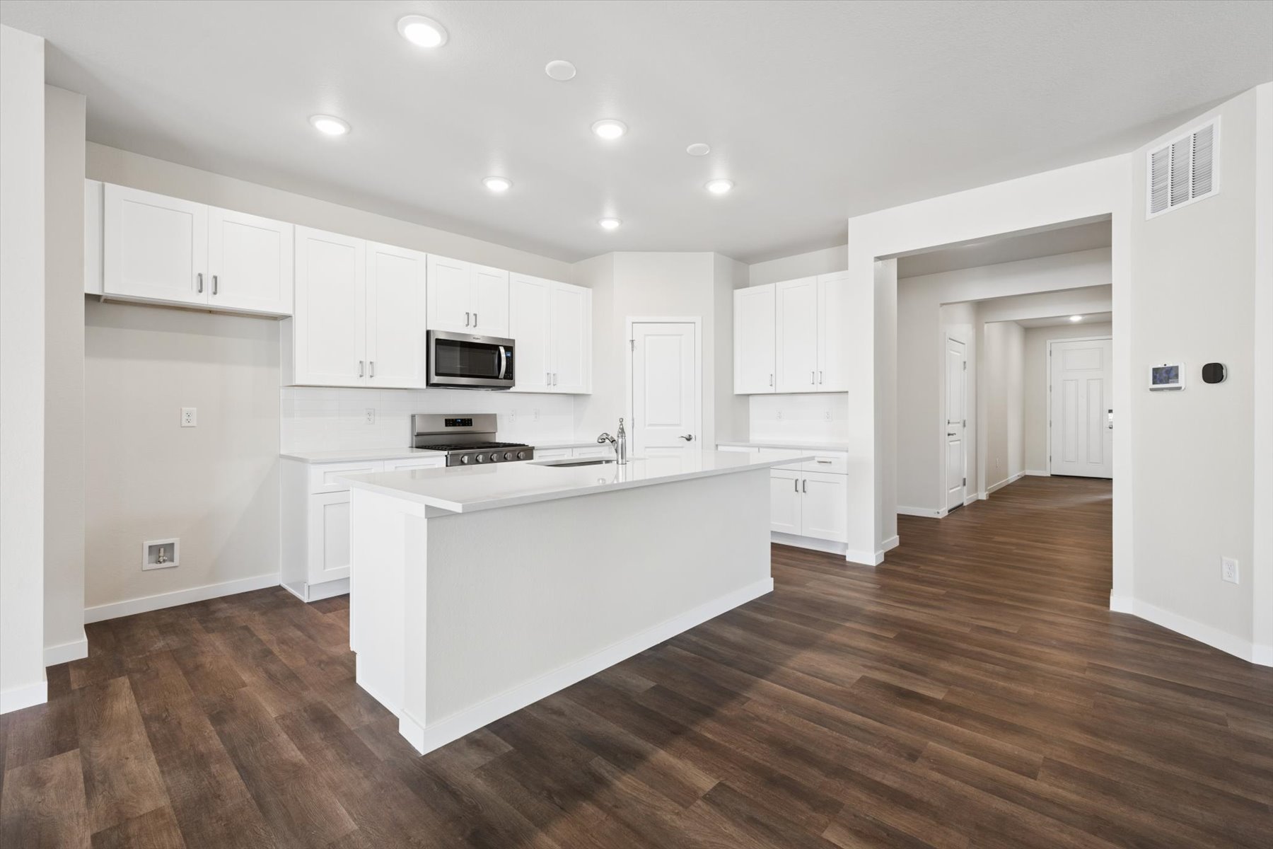 A kitchen with white cabinets.