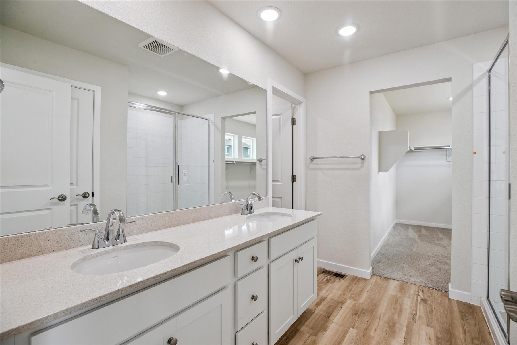 A bathroom with a large mirror.