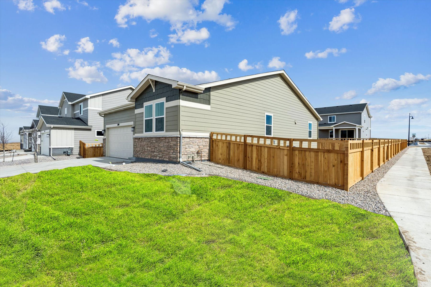 A house with a fence and grass.