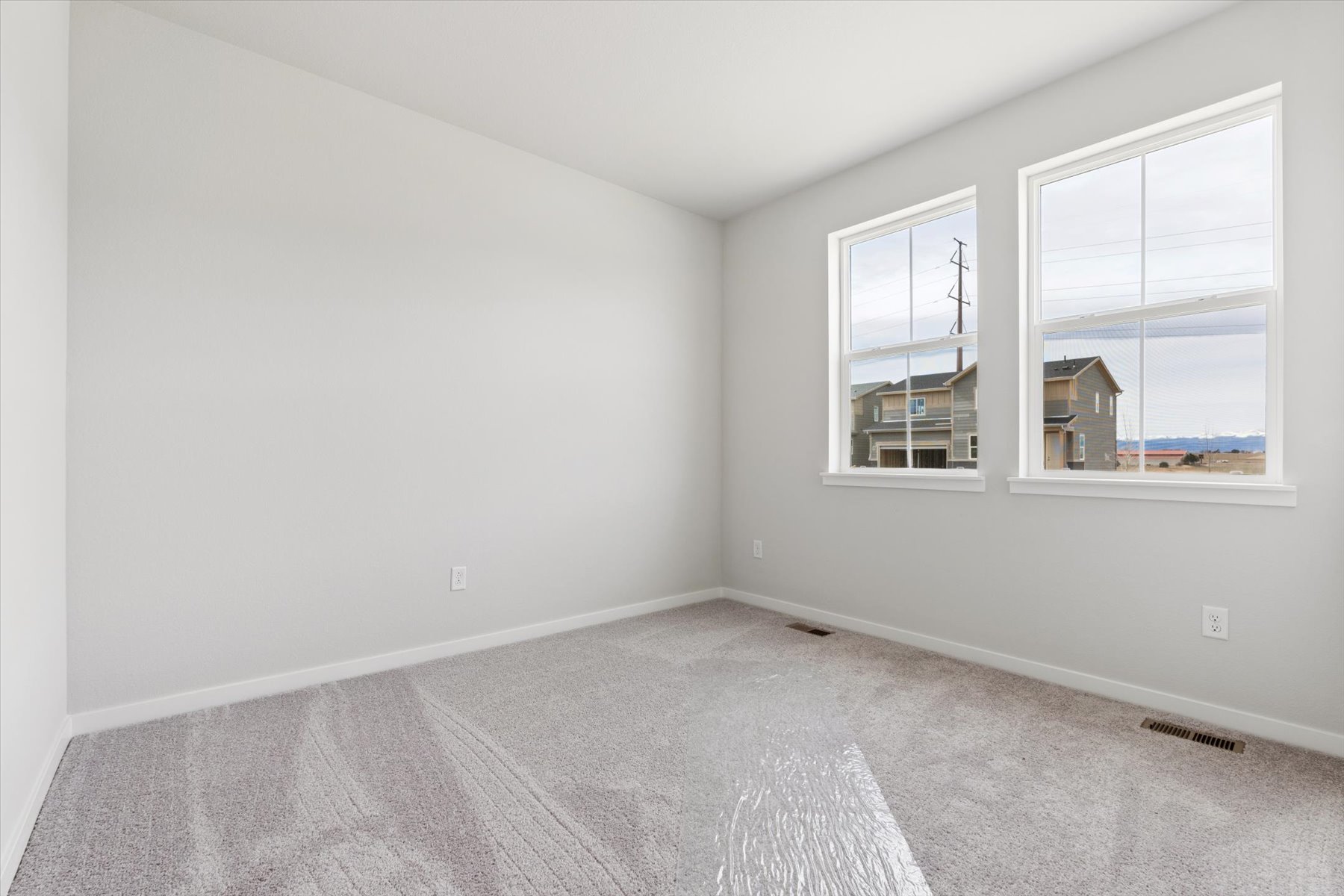 A room with a window and a view of the city.