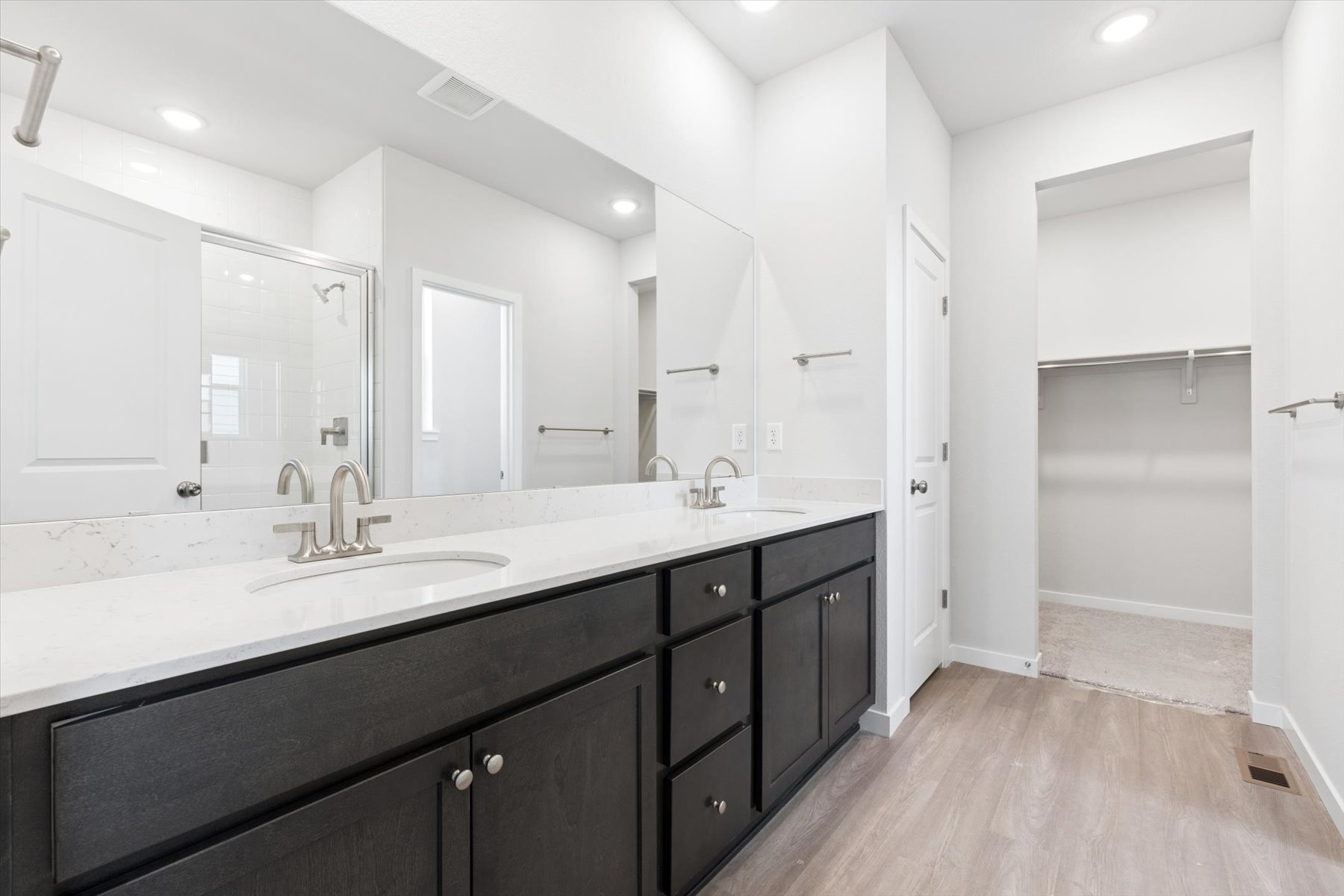 A bathroom with a large mirror.