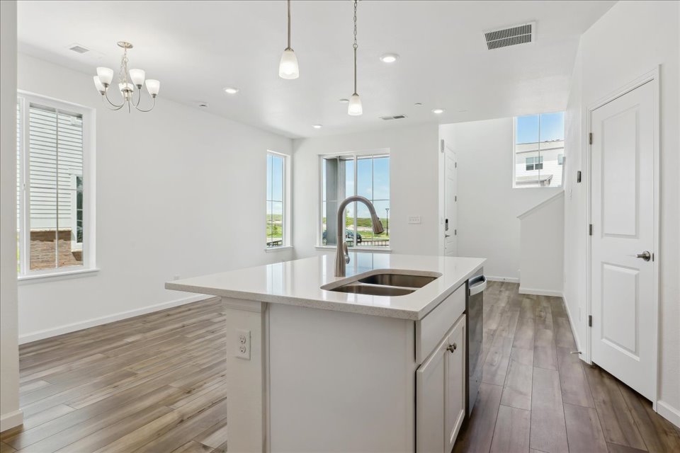A kitchen with a sink and a mirror.