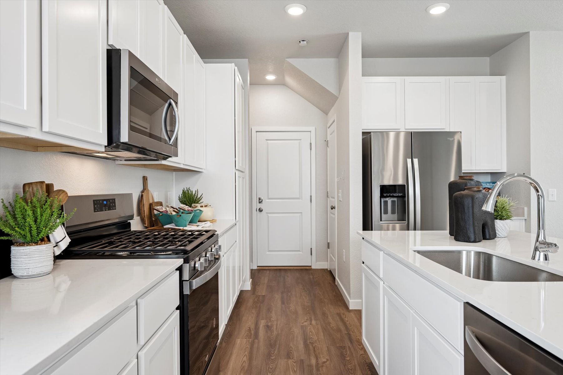 A kitchen with white cabinets.