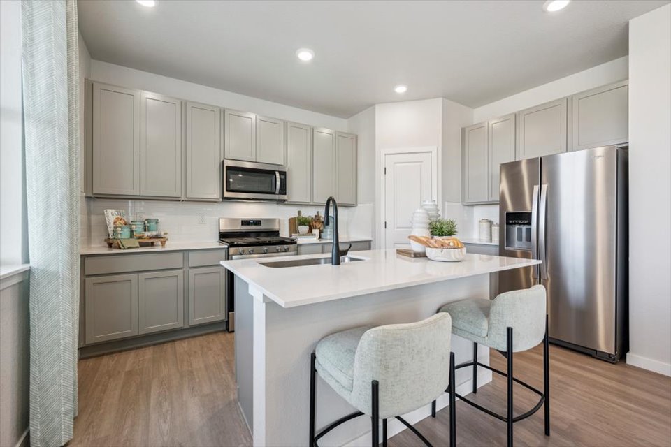 A kitchen with white cabinets.