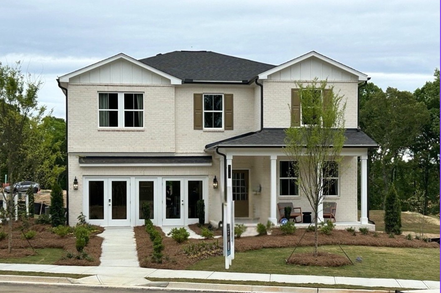 A house with trees in the front.