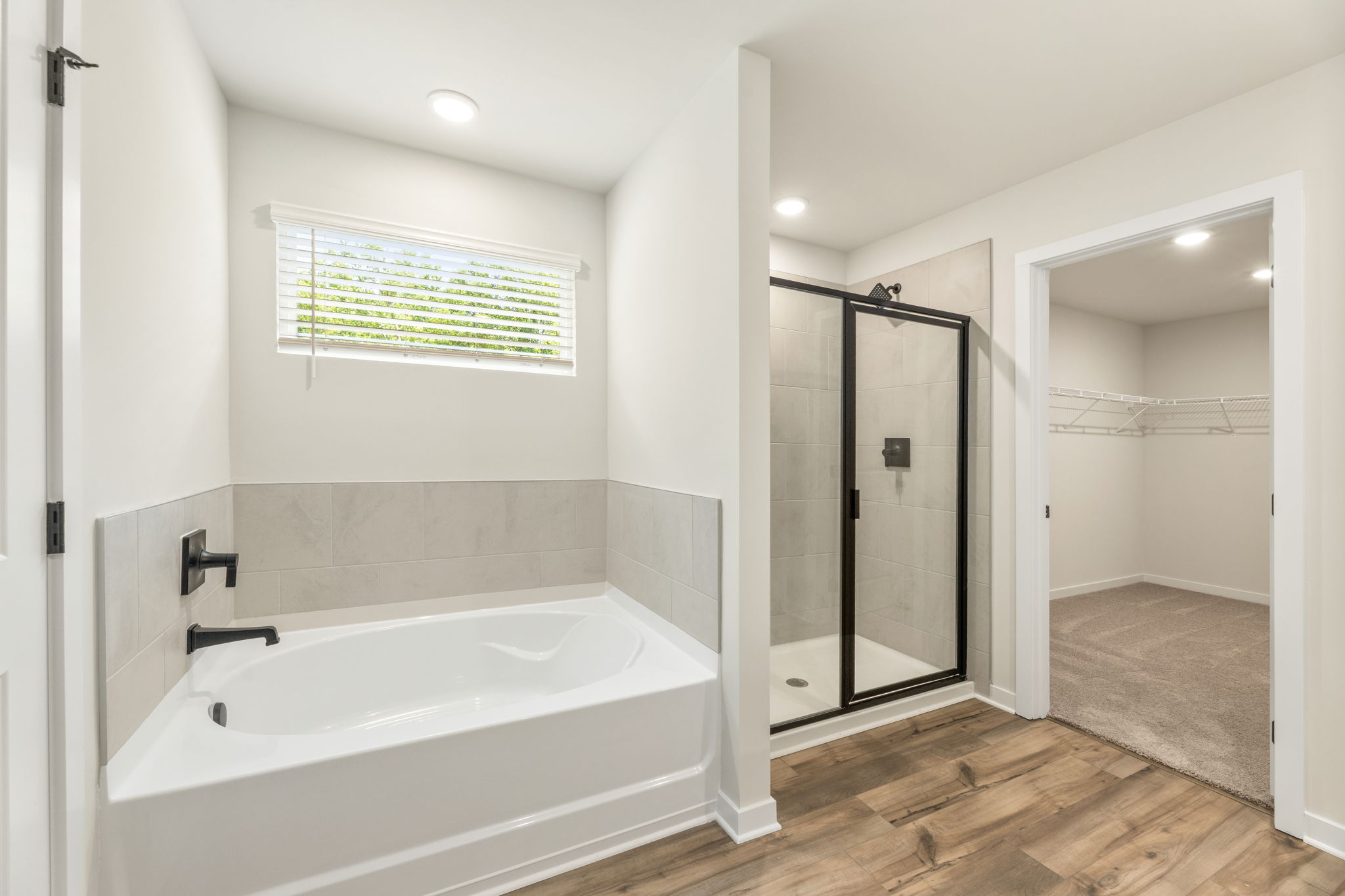 A bathroom with a tub and shower.