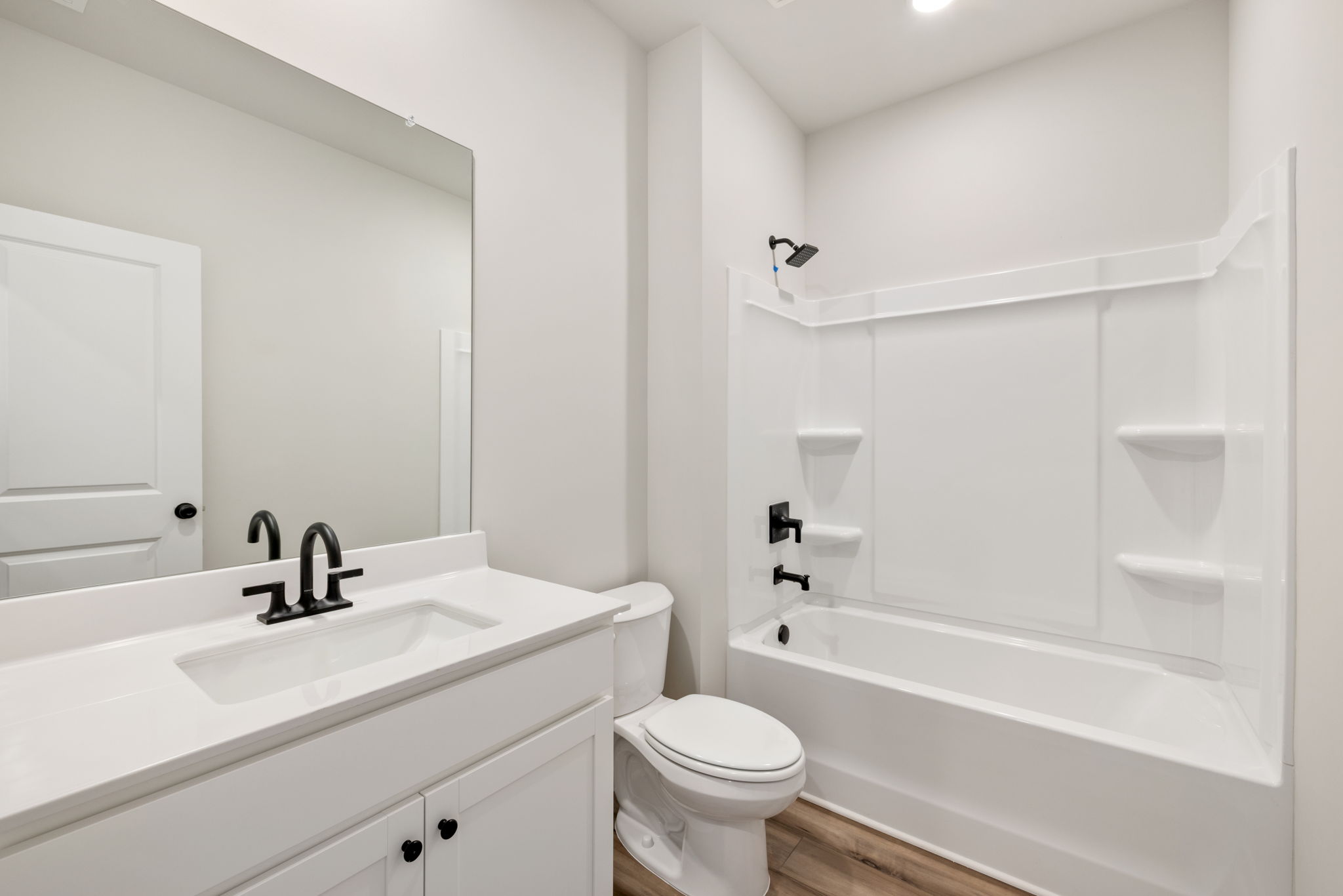 A bathroom with a tub sink and toilet.