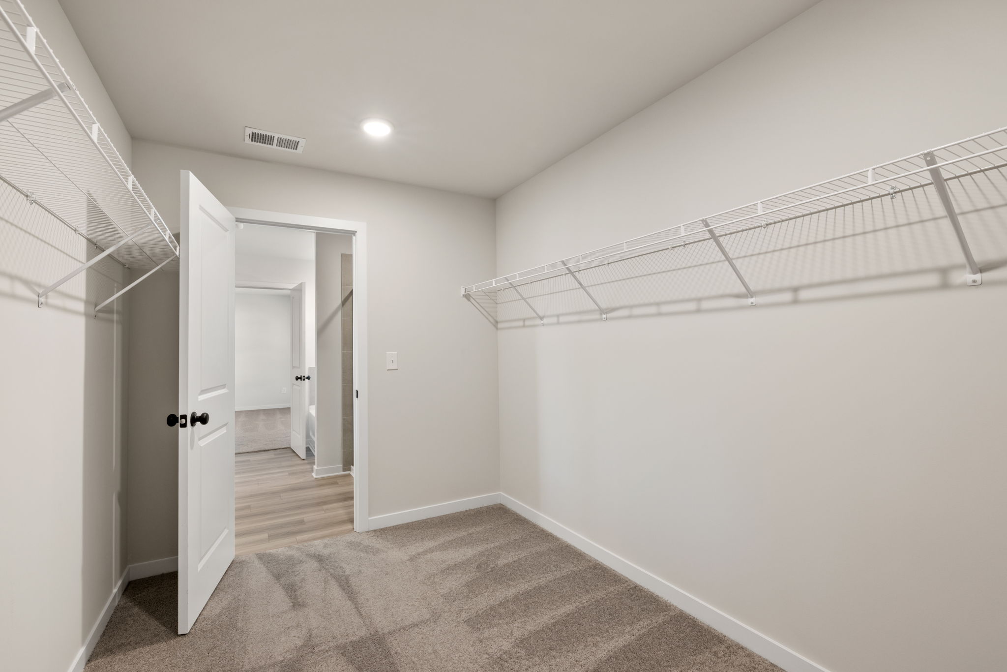 A hallway with white walls.