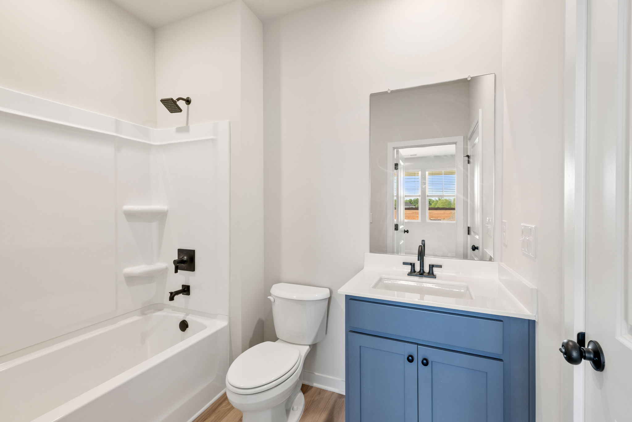 A bathroom with a tub sink and toilet.