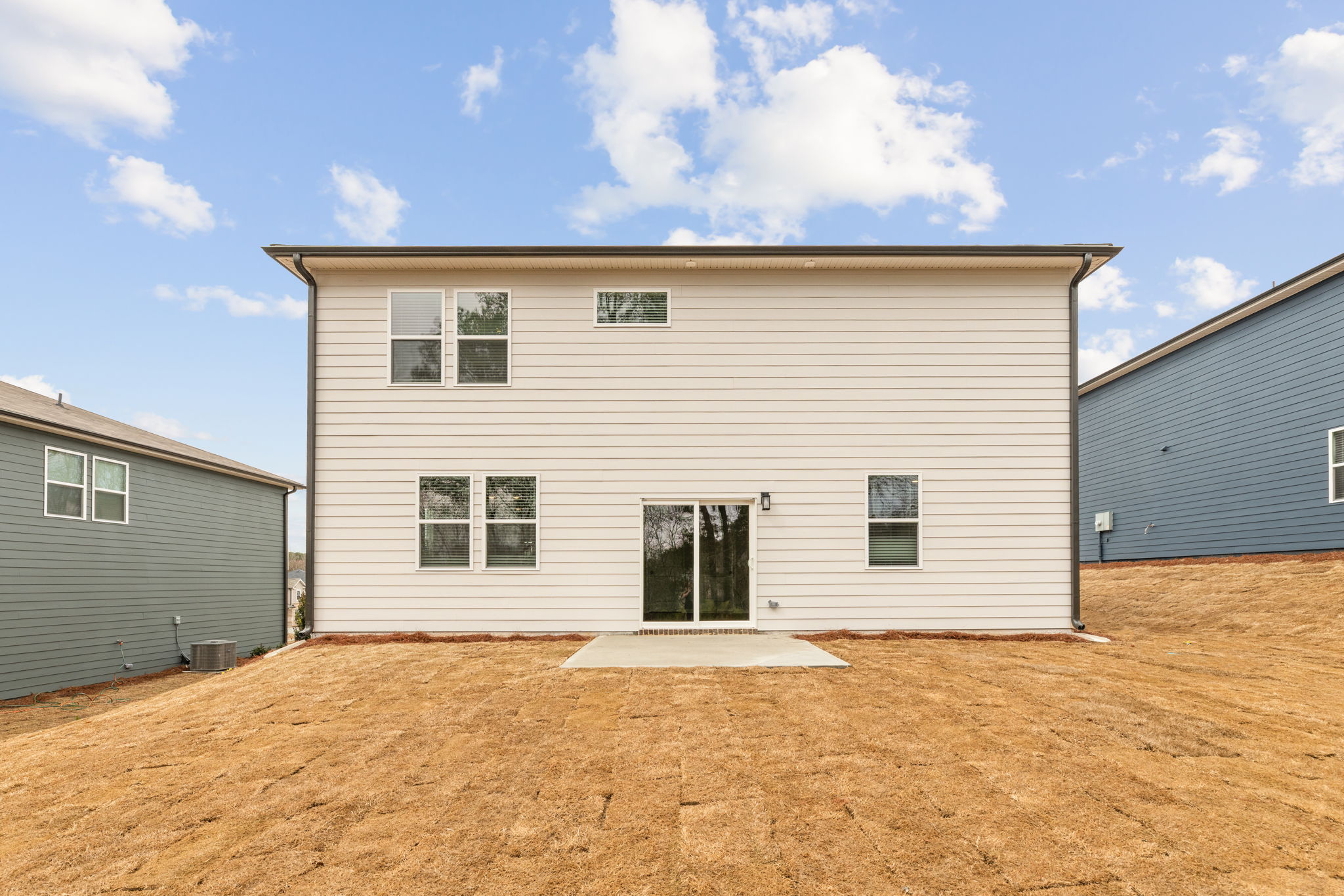A building with a dirt yard.