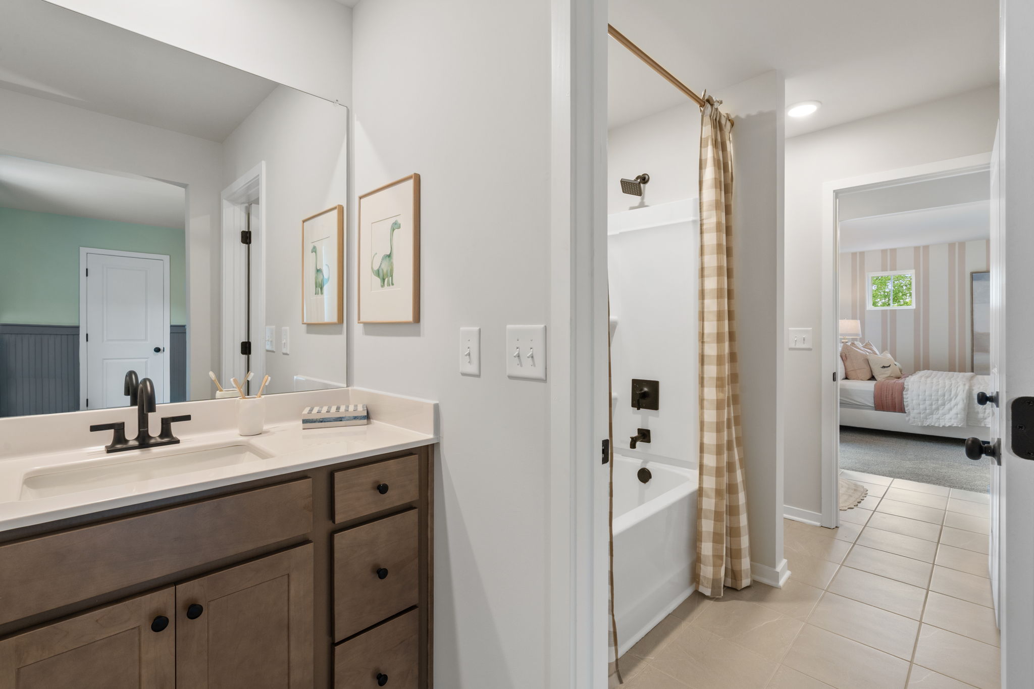 A bathroom with a sink and a bed.