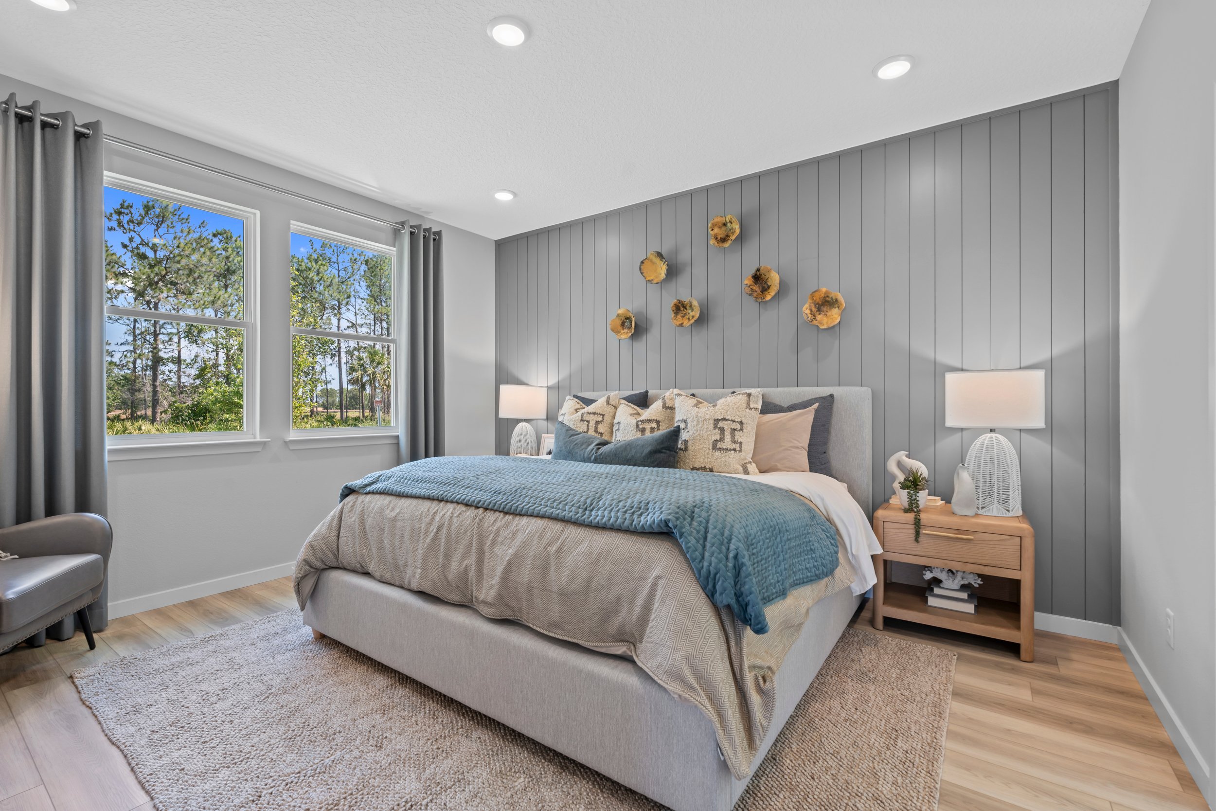 Coronado Model Home Primary Bedroom with Large Bed at Reserve East in Flagler Beach