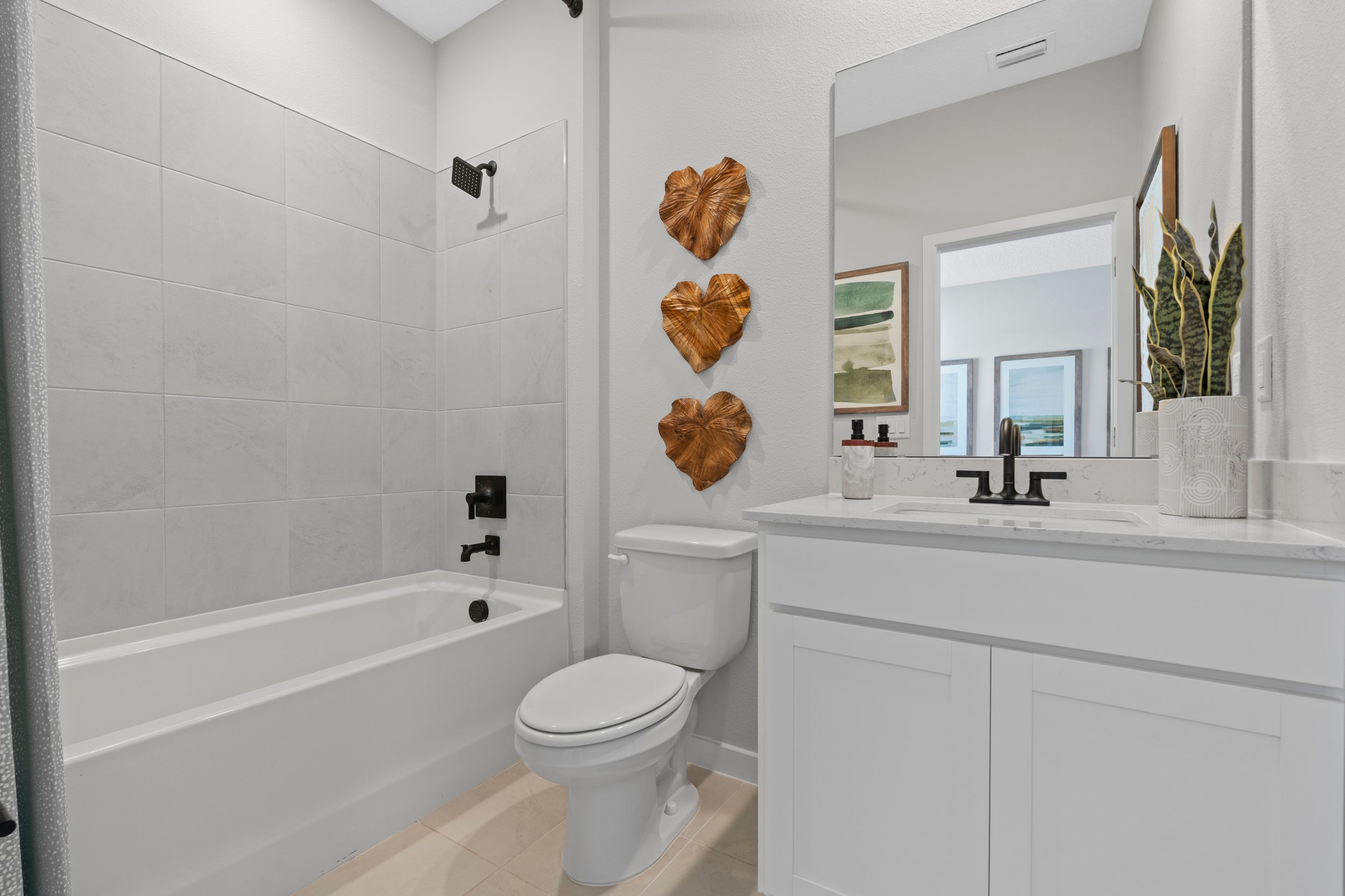 Kenai Model Home Guest Bath with Tub and Shower at Reserve East in Flagler Beach