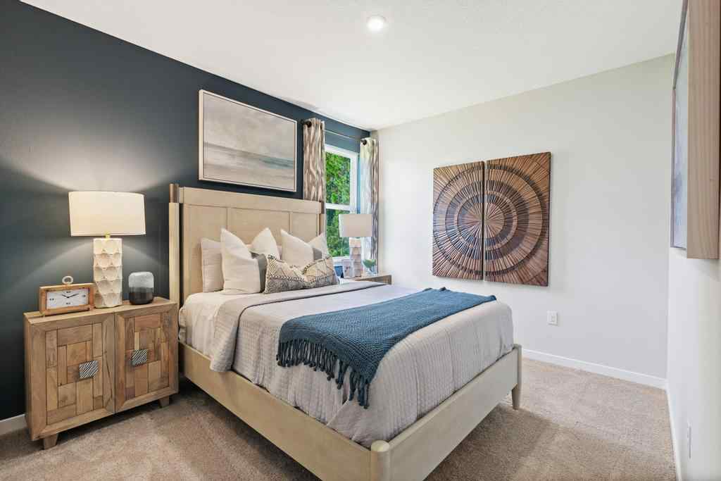 A bedroom with a bed and lamps.