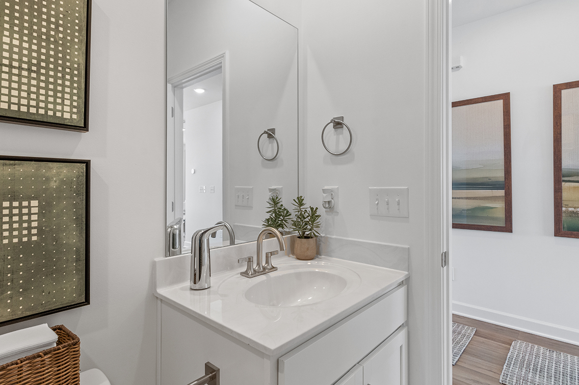 A bathroom with a sink and mirror.