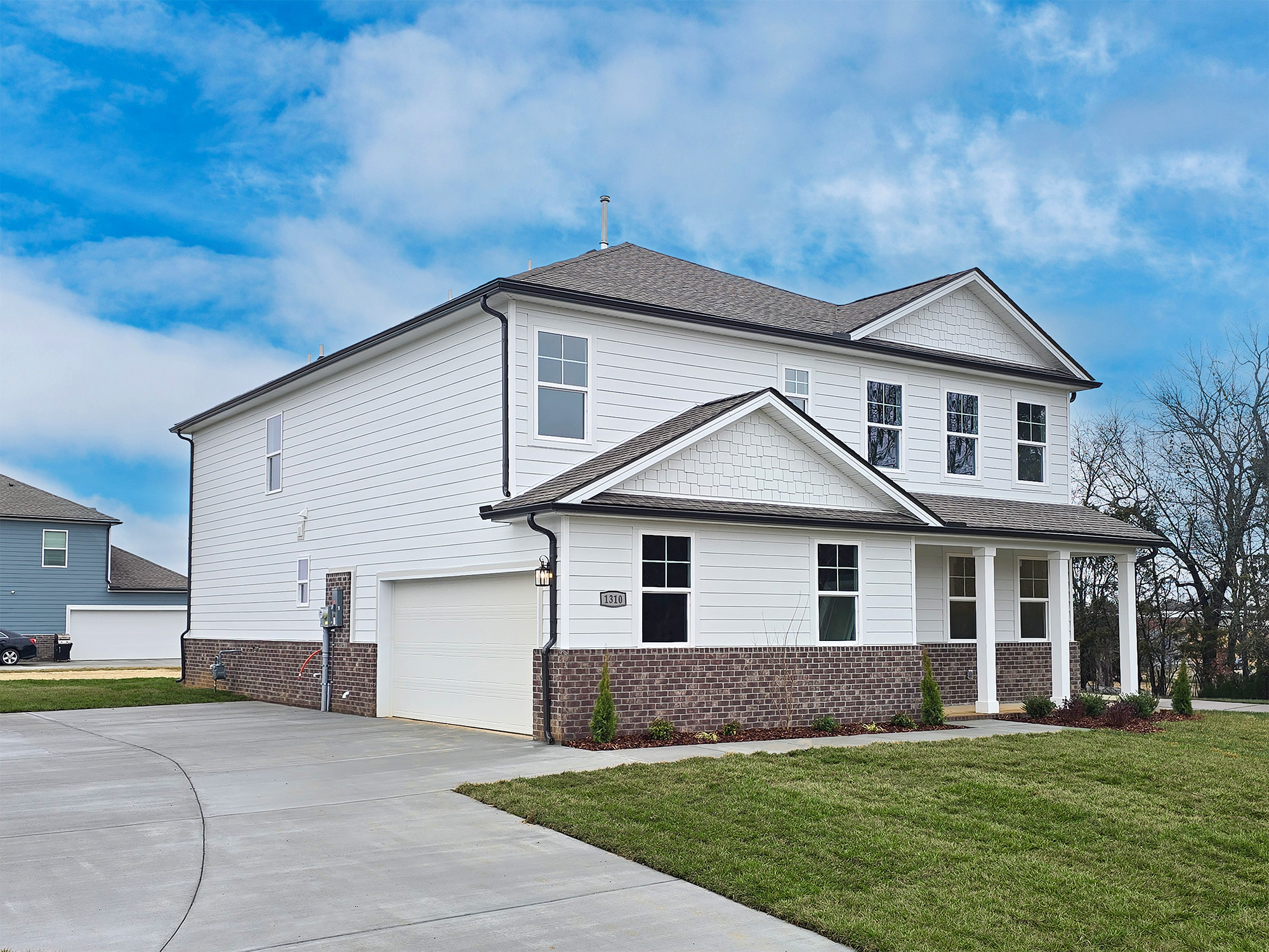 A white house with a driveway.