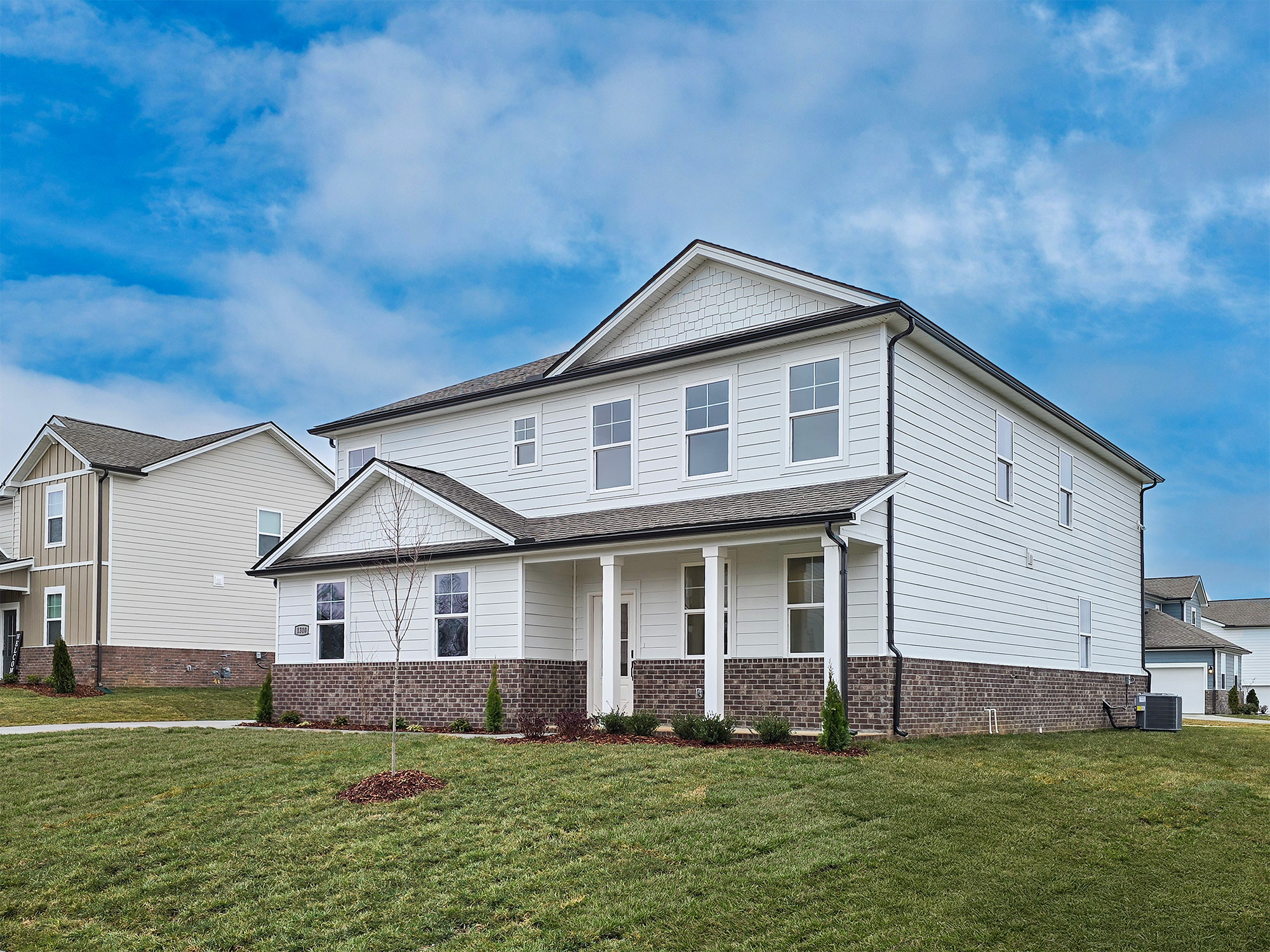 A large house with a brick wall.