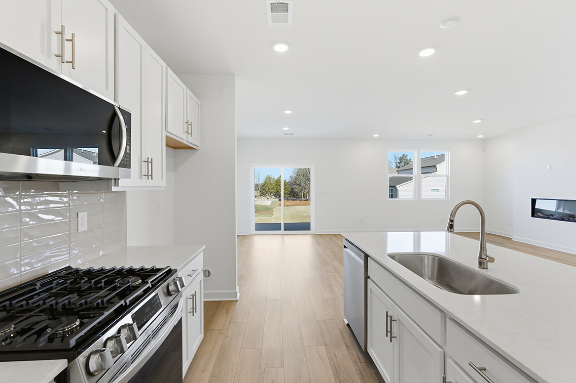 A kitchen with white cabinets.