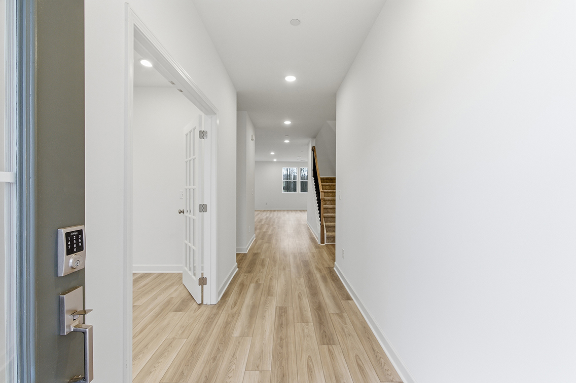 A hallway with white doors.