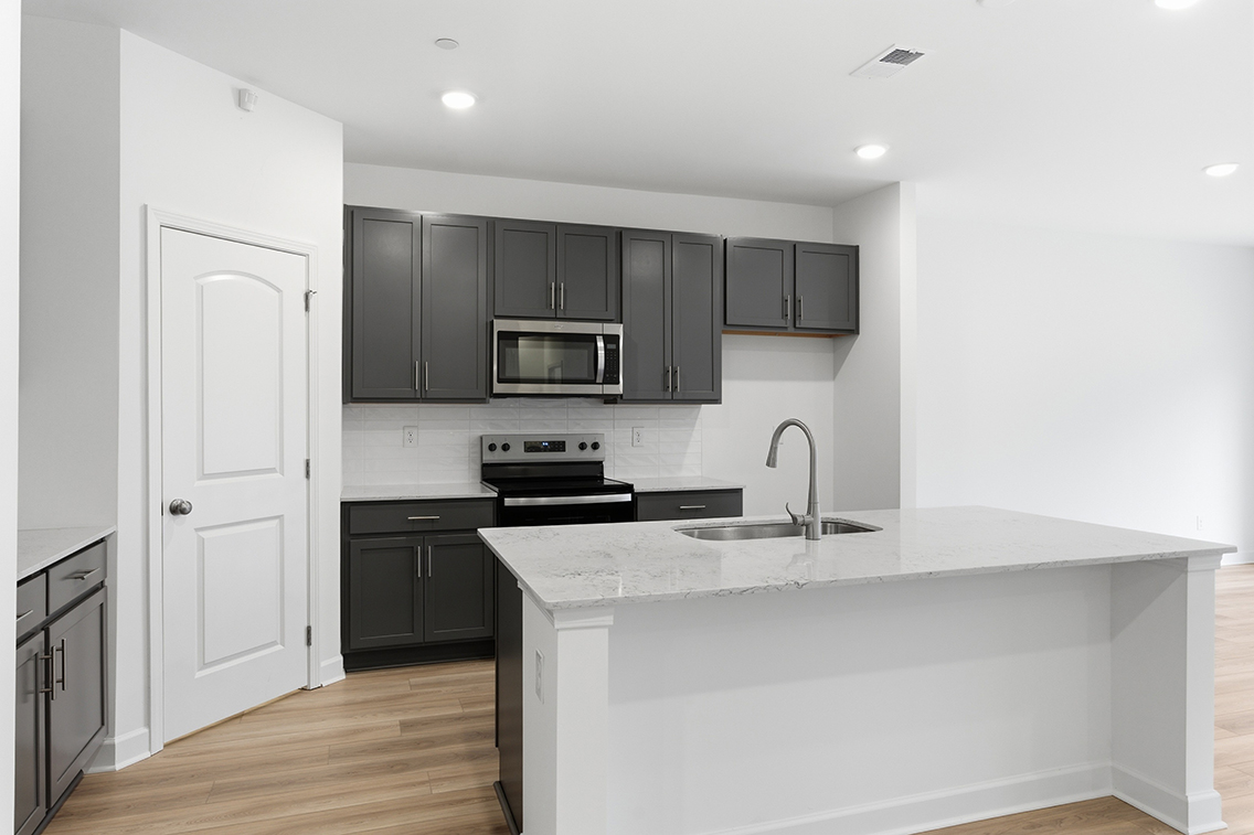 A kitchen with black cabinets.