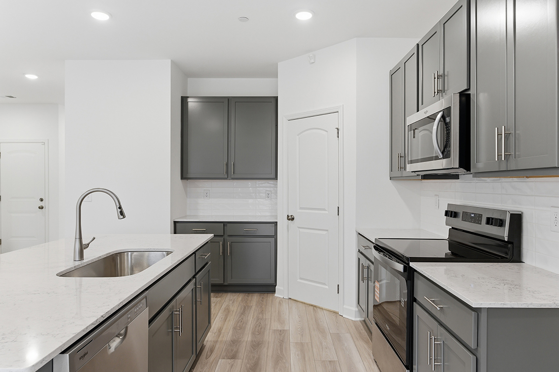 A kitchen with black cabinets.
