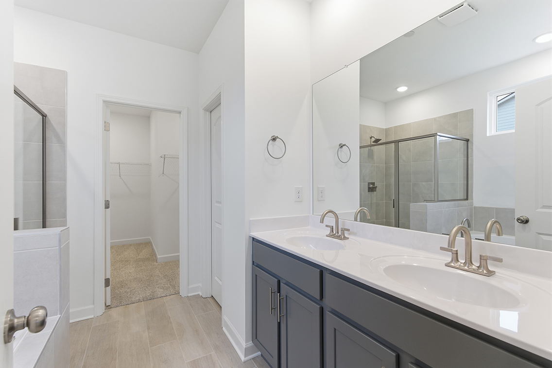 A bathroom with a large mirror.