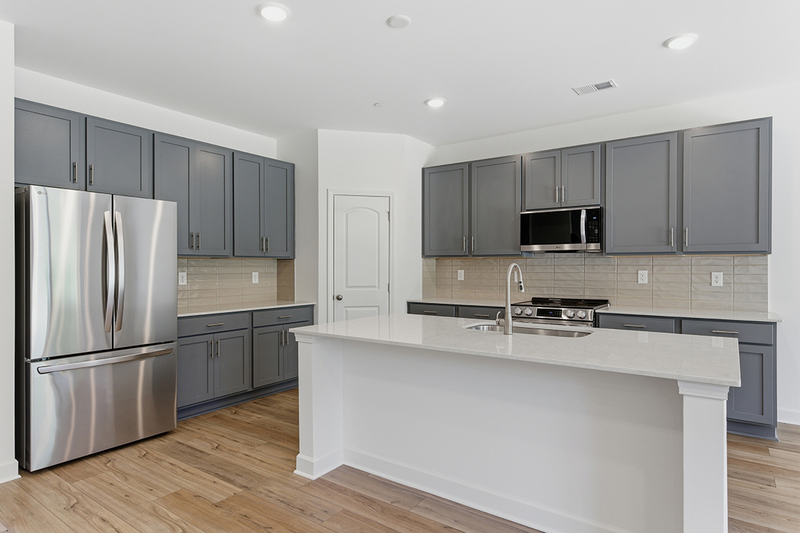 A kitchen with black cabinets.
