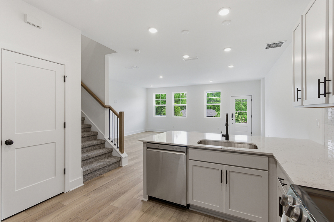 A kitchen with white cabinets.