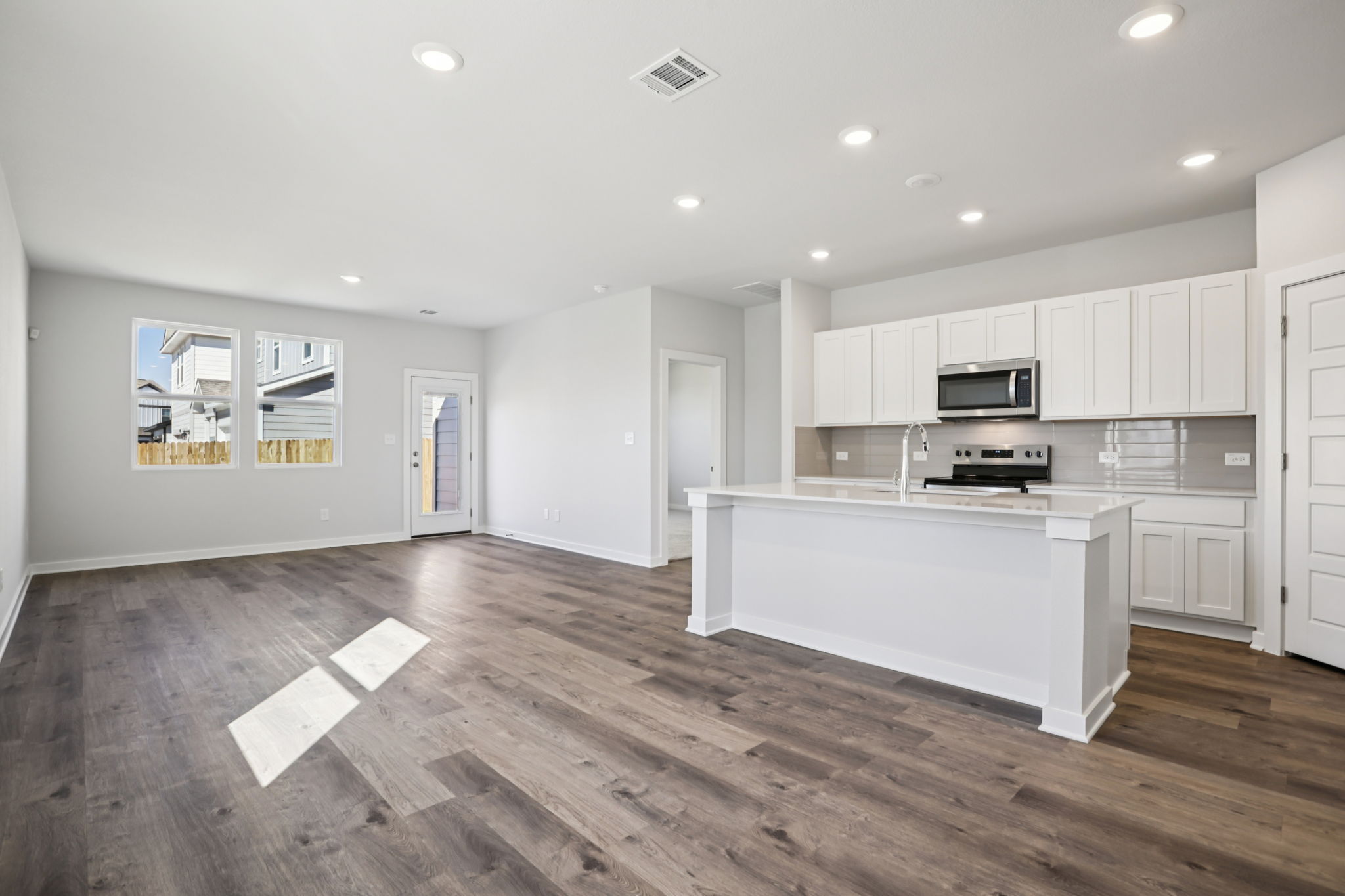A large kitchen with white cabinets.
