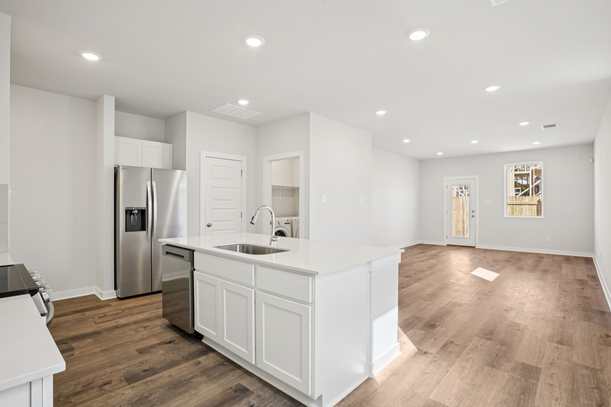 A kitchen with white cabinets.