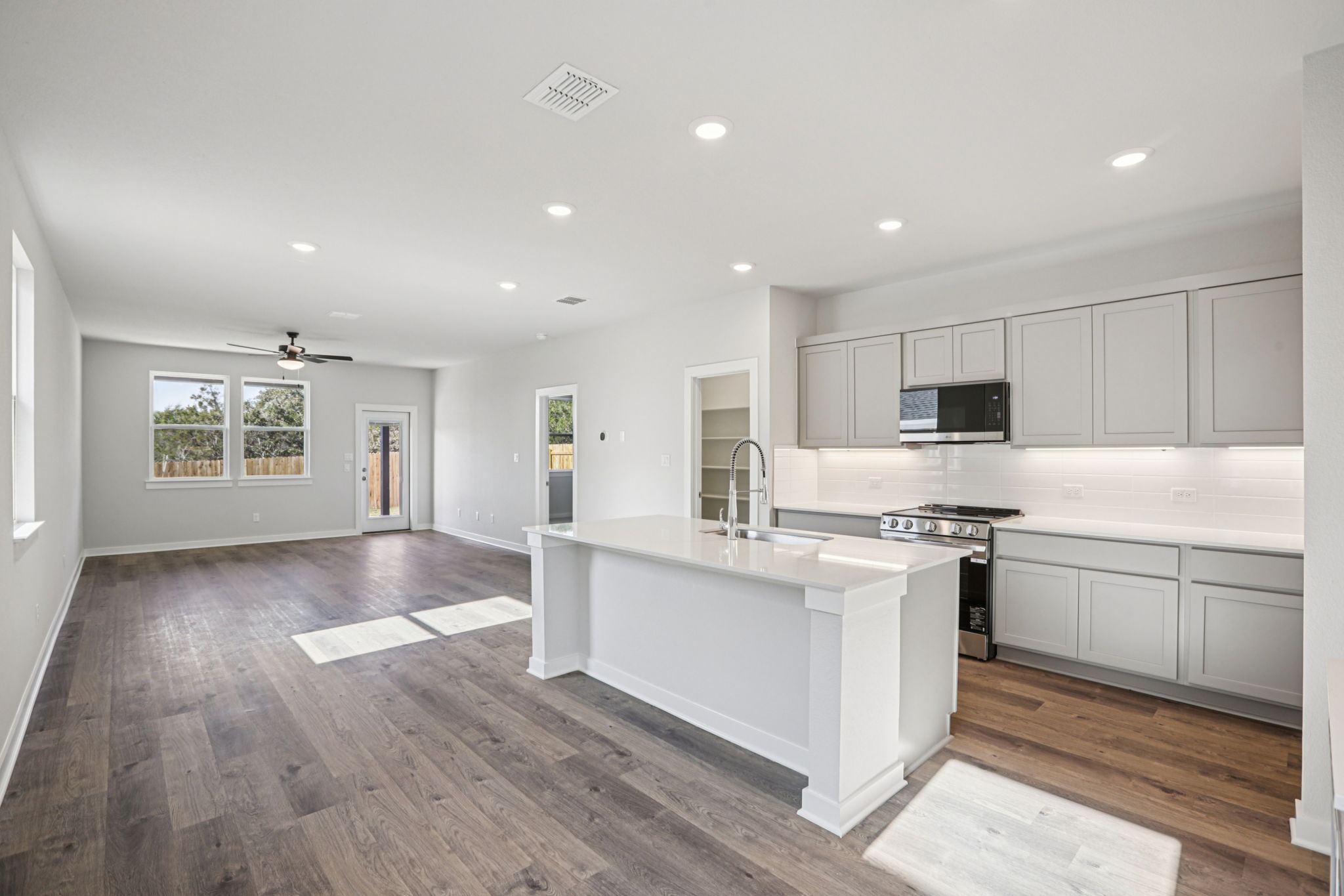A kitchen with white cabinets.