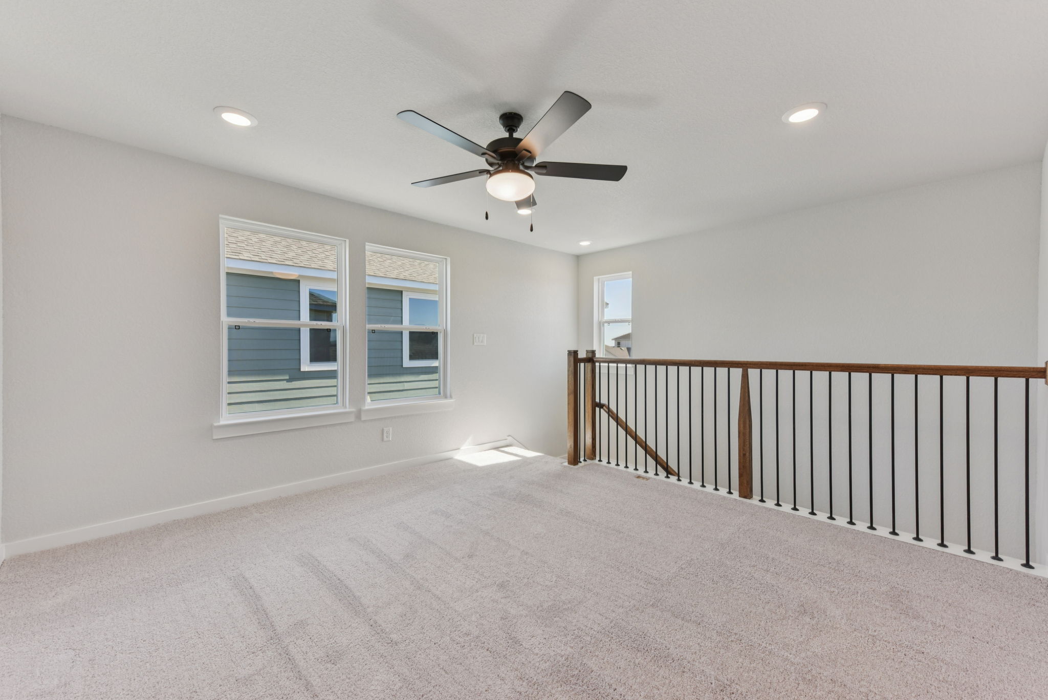 A room with a ceiling fan and a window.