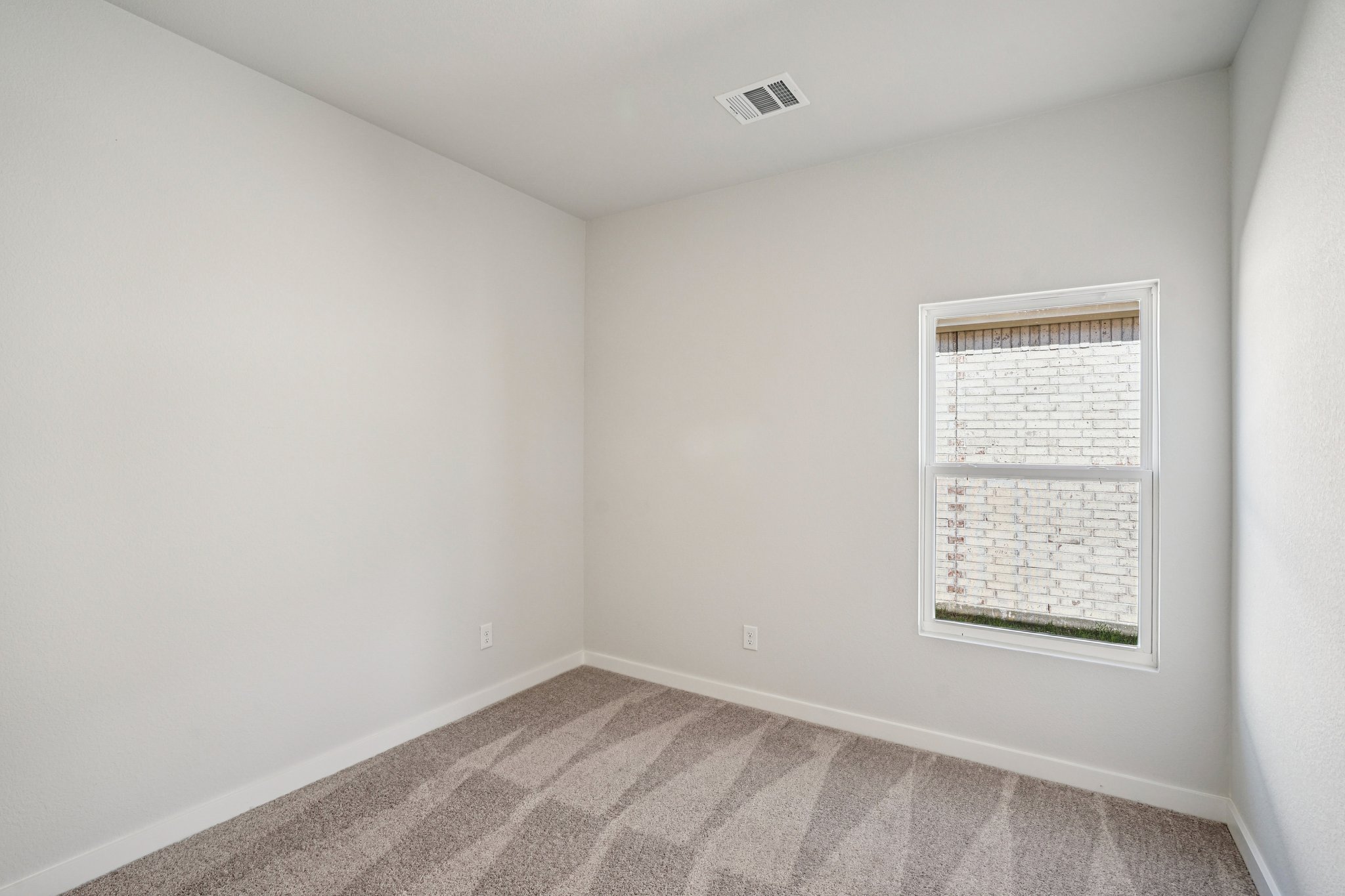 A room with a carpet and a wall with a sign on it.