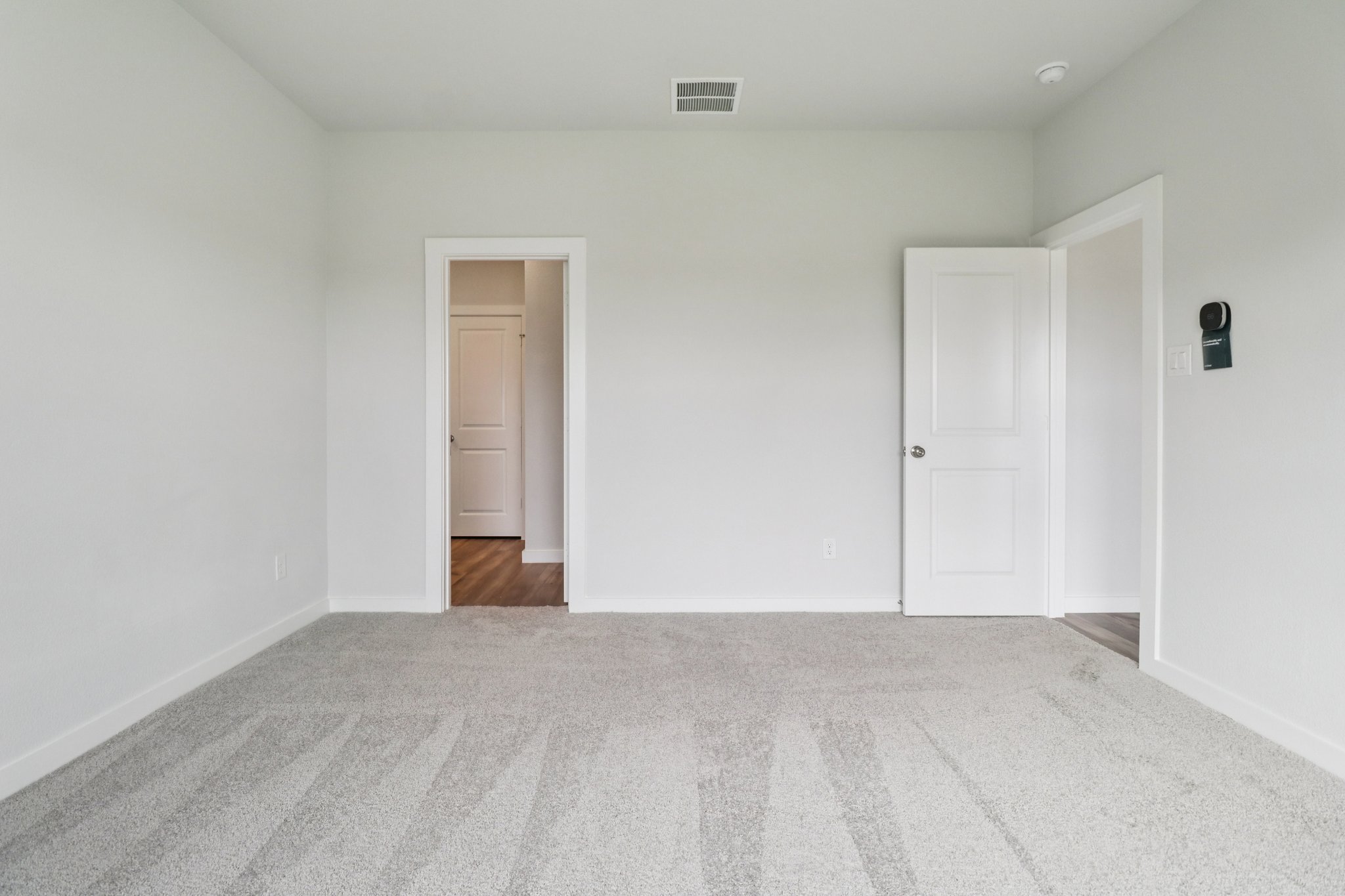 A hallway with white doors.