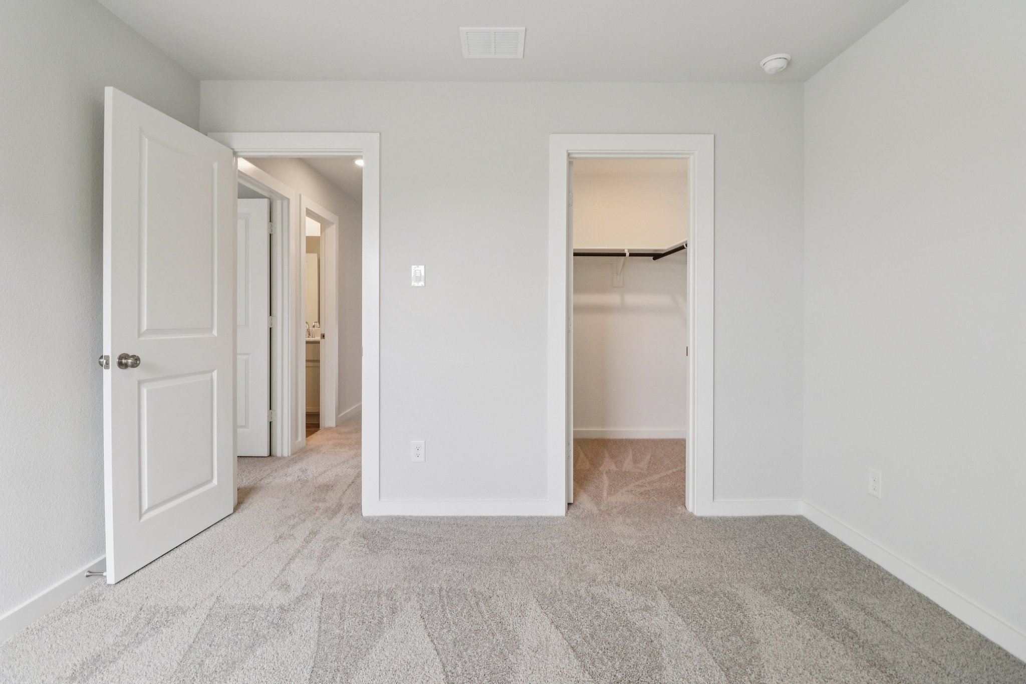 A hallway with white walls.