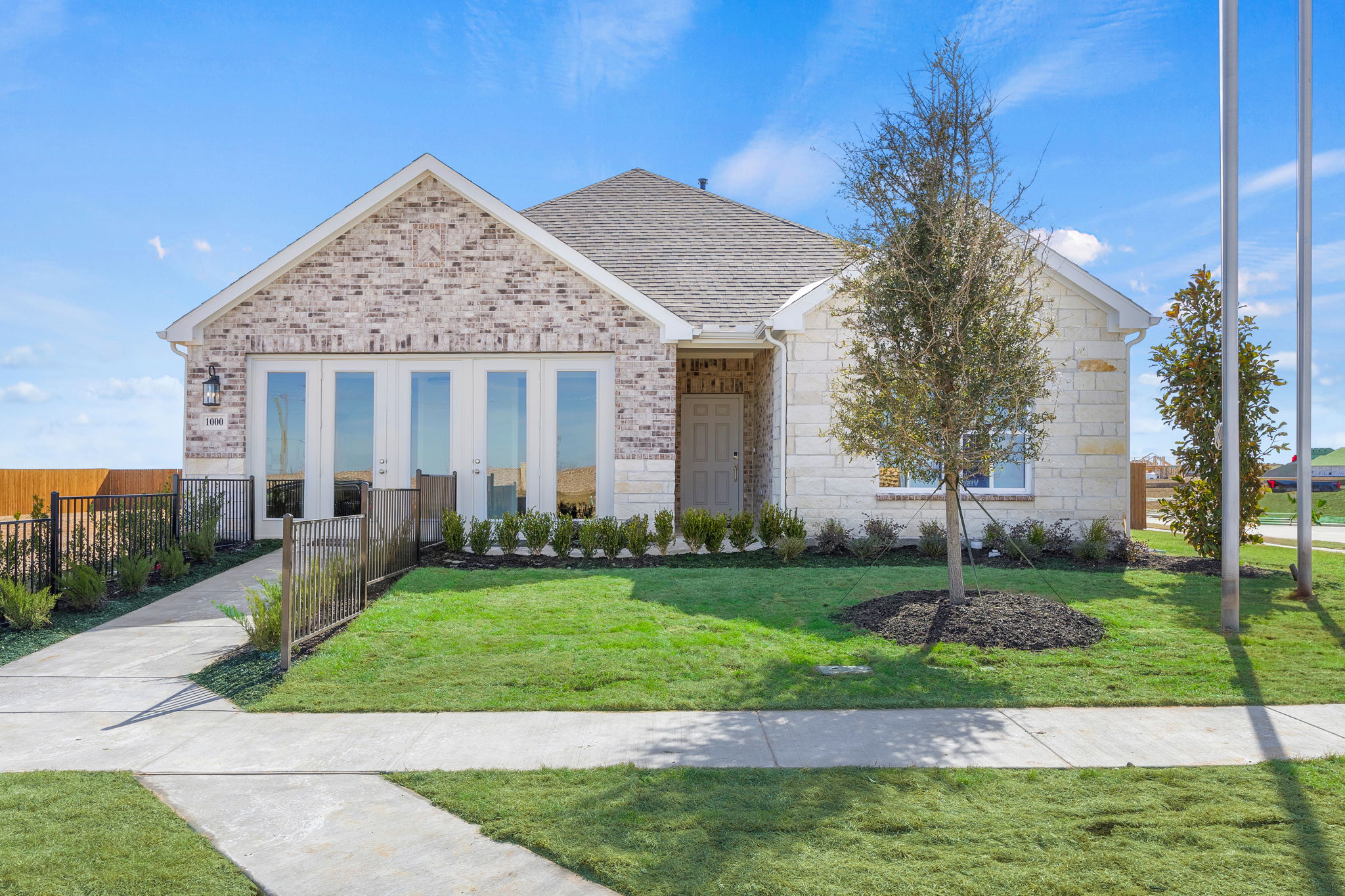 A house with a fence and trees.