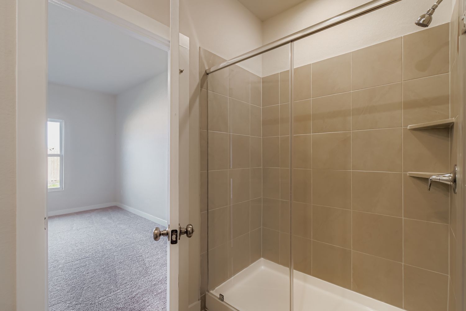 A bathroom with a shower unit.