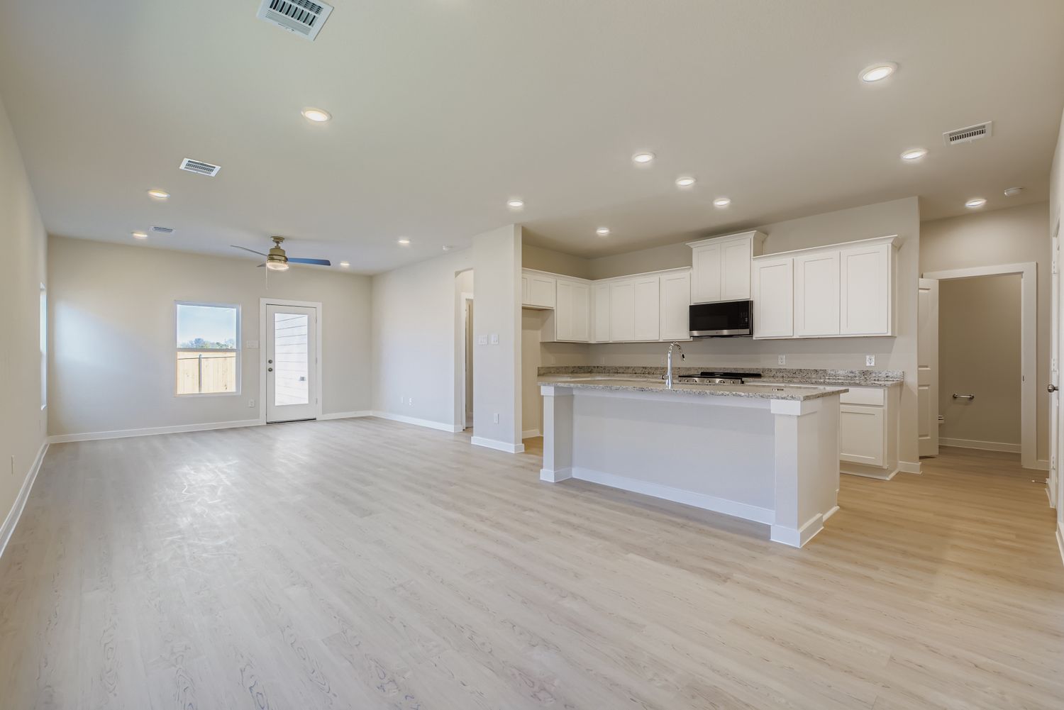 A large kitchen with white cabinets.