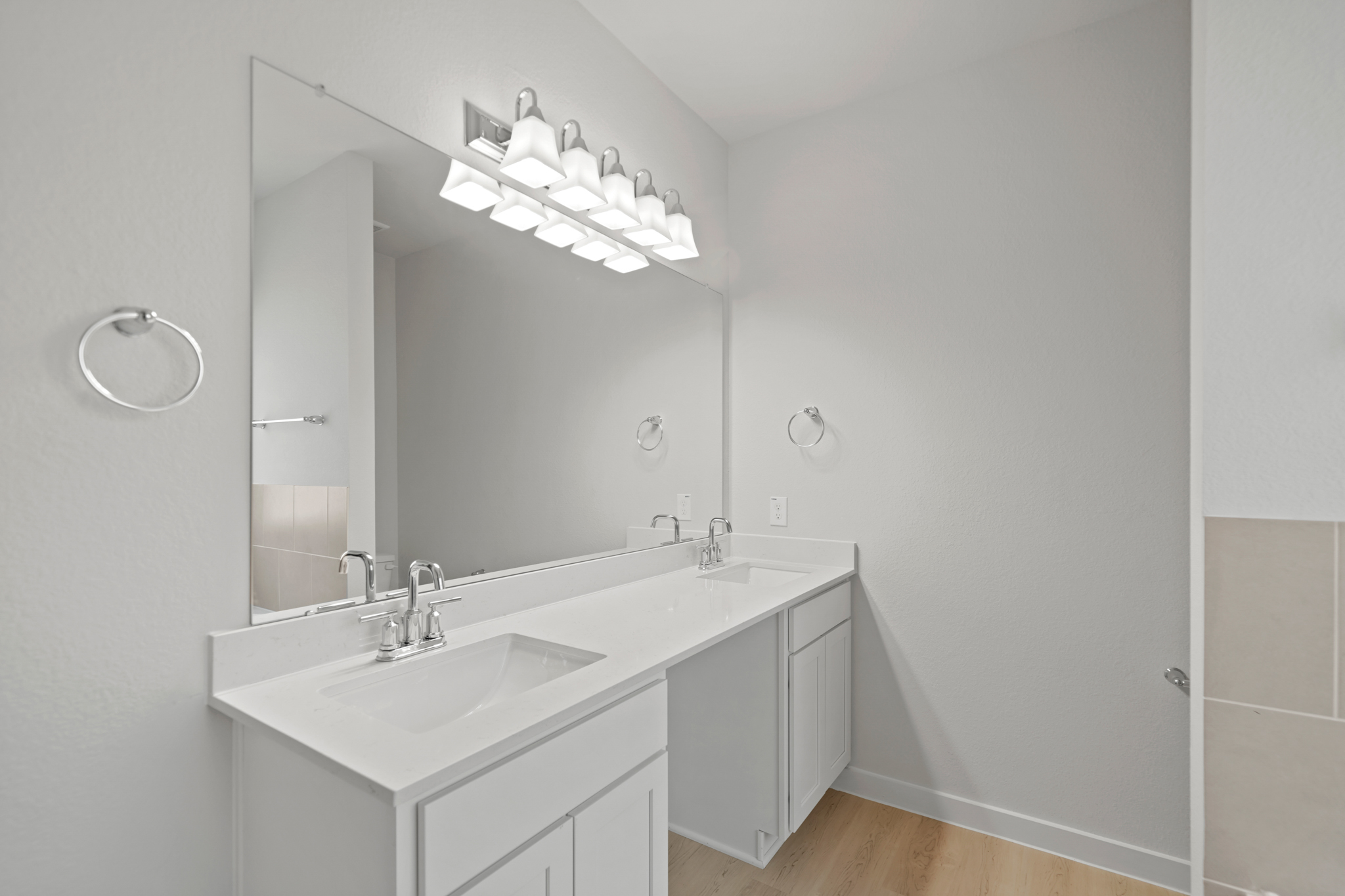 A bathroom with a large mirror.