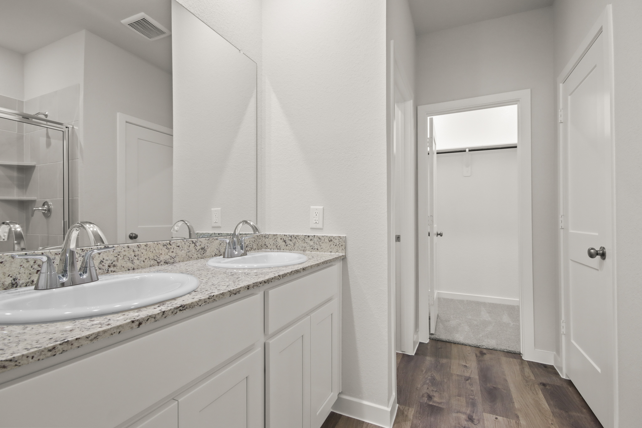 A bathroom with a large mirror.